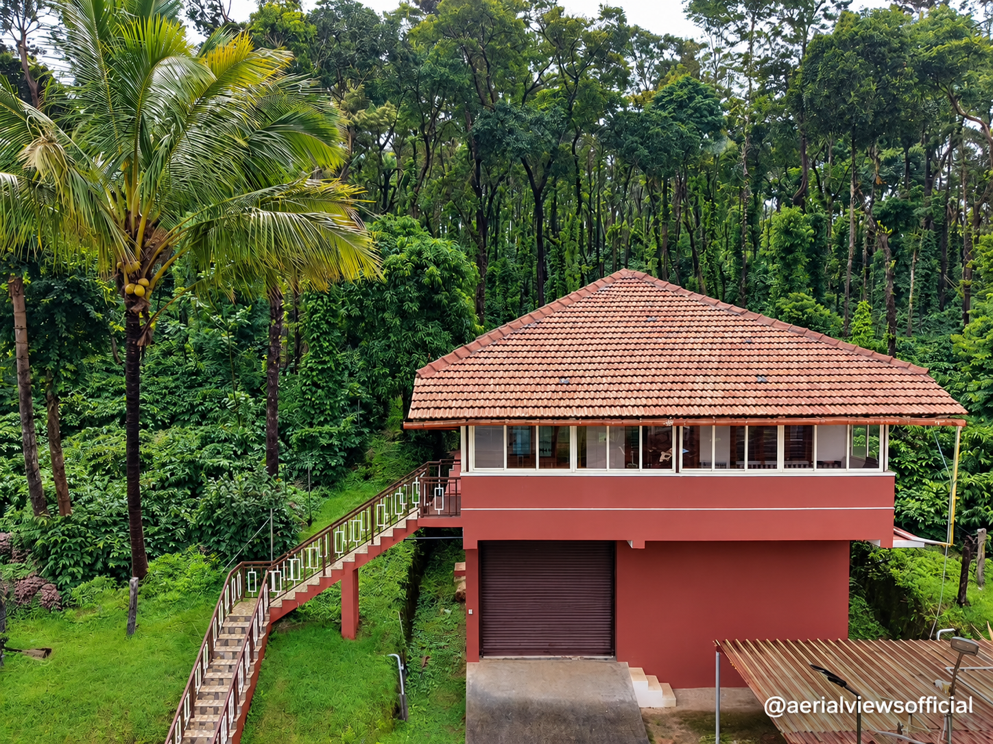 Aerial view of a property surrounded by greenery